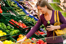 Woman picking vegetables at a super market