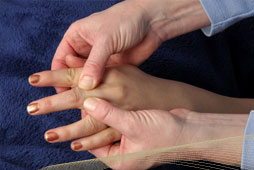Therapist massages and mobilises patient's hand